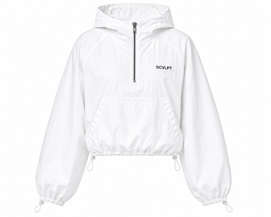 A white cropped hooded windbreaker jacket with a half-zip front, drawstring hem, and elastic cuffs, featuring the brand name SCVLPT printed in black on the left chest.